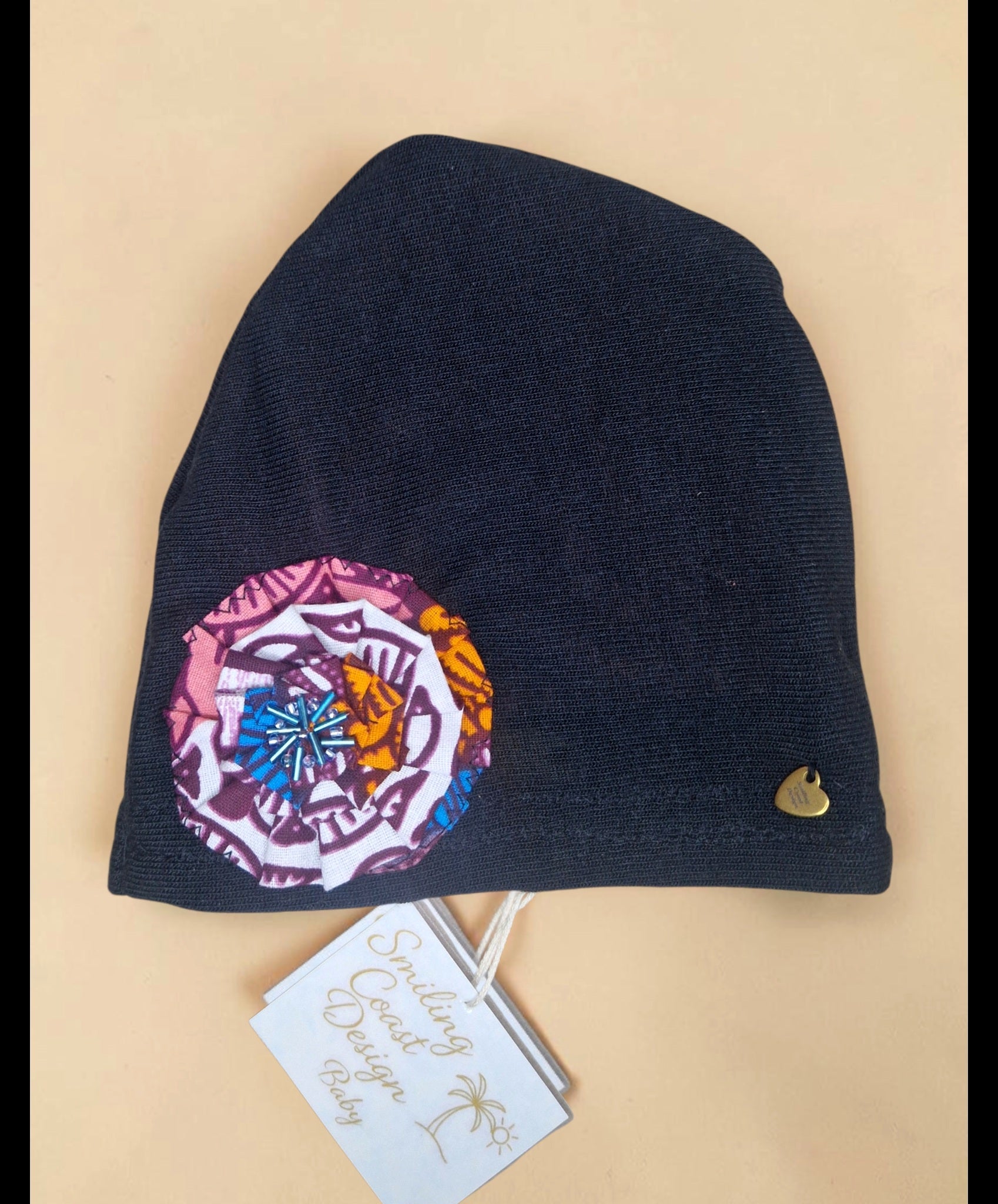 Baby Beanie with African waxprint Fabric Flower and hand-sewn beads/ Size 0-6 Months (199kr)